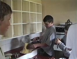 Organised chaos in the tiny Members' Kitchen at Tyncornel youth hostel